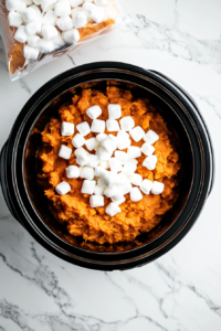 adding-marshmallows-on-crockpot-sweet-potatoes in the last 15 min so that it melts easily as the topmost layer
