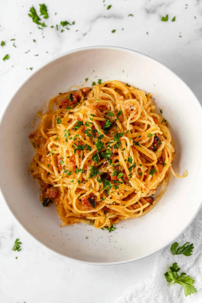 This image highlights tender spaghetti squash, slow-cooked and tossed in a savory sauce, topped with fresh cilantro.