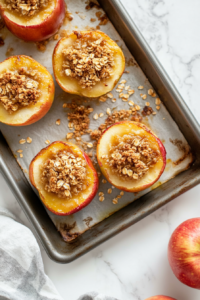 Cored apples generously filled with a sweet oat and brown sugar mixture, ready to be baked to golden perfection.