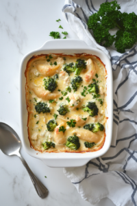 This image shows the final dish, fresh out of the oven, with bubbling cheese, creamy Alfredo sauce, and vibrant cilantro garnish.