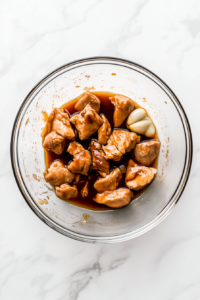 marinating-chicken-pieces-with-teriyaki-sauce-in-a-bowl