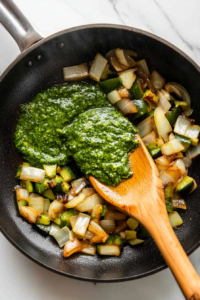 pouring-creamy-poblano-sauce-into-the-skillet-with-chicken