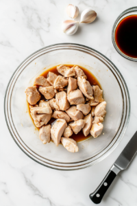 preparing-chicken-pieces-for-marinade-in-a-bowl