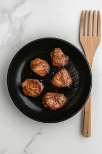 searing-chicken-pieces-in-a-hot-skillet-for-chicken-poblano