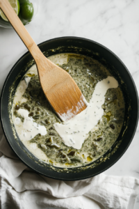 stirring-cream-lime-juice-and-honey-into-the-poblano-sauce-for-chicken-poblano