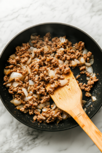 draining-grease-and-returning-sausage-to-the-skillet-for-further-cooking-2