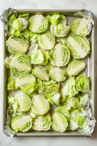 arranging-sliced-cabbage-steaks-evenly-on-sheet-pan-for-grilling