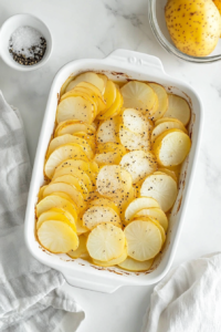 This image shows butter melting in a pan, the first step in creating a velvety cheese sauce that will coat the potatoes in creamy perfection.