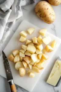 This image shows potatoes cooking in a Crockpot, absorbing butter and becoming tender enough for mashing.