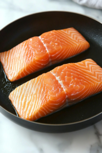 This image shows a hot pan being preheated, ready to perfectly sear the salmon for a delicious golden crust.