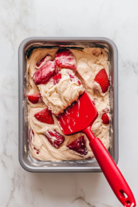 topping-the-strawberry-rhubarb-bread-batter-with-crumble-before-baking