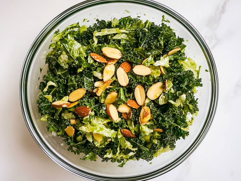 This image shows a close-up top-down shot of the finished Chick-fil-A kale salad, served in a white ceramic bowl over a white marble countertop.