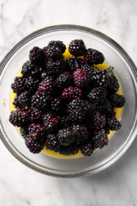 blackberries-tossed-in-glass-bowl-with-butter-and-sugar-cornstarch