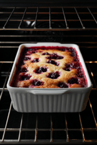 blackberry-cobbler-baking-in-white-dish-inside-oven