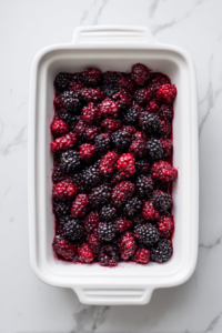 blackberry-mixture-in-white-baking-dish-on-marble-counter