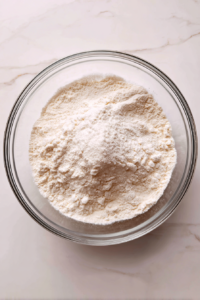 dry-ingredients-in-glass-bowl-flour-sugar-baking-powder-salt