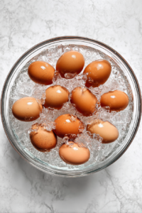 eggs-in-ice-bath-glass-bowl-on-white-marble